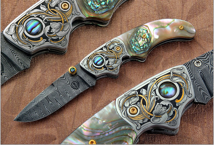 Engraved abalone handled folding knife