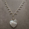 Heart shaped silver mother of pearl pendant on silver rainbow moonstone necklace