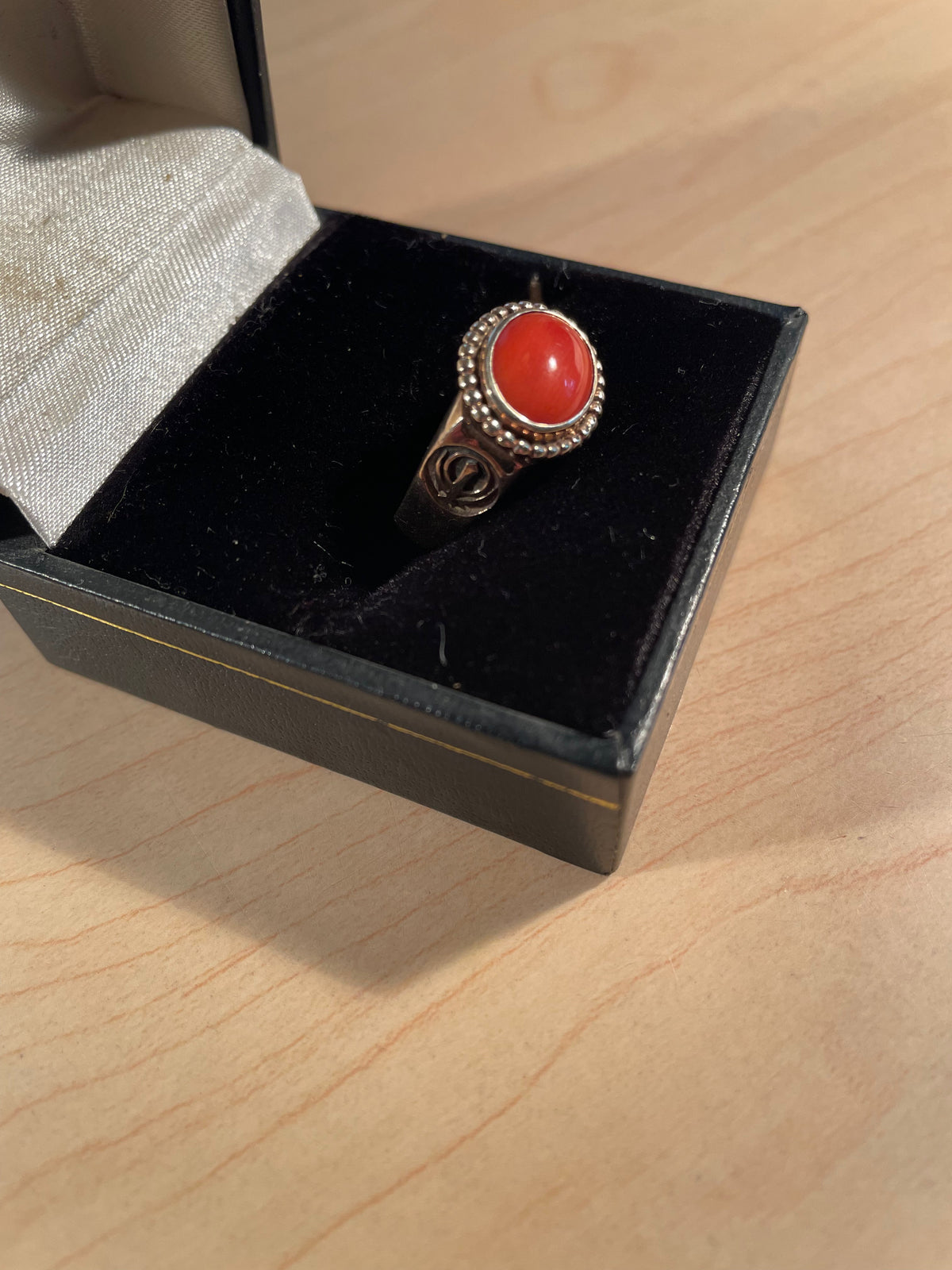 Solid gold and oxblood coral ring with Khanda symbols