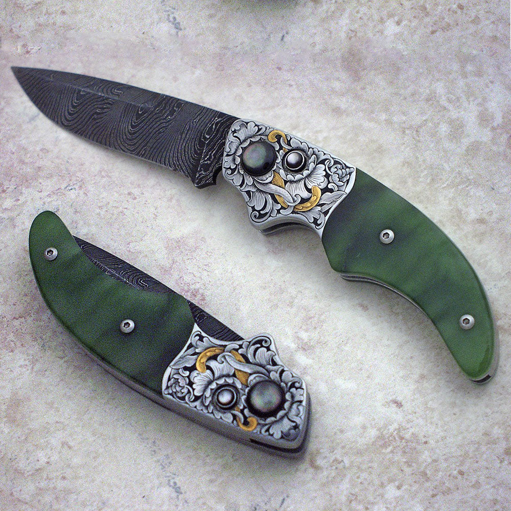 Engraved jade button lock folding knife
