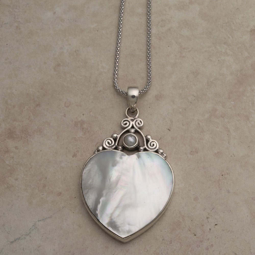 Heart shaped silver mother of pearl pendant on silver rainbow moonstone necklace